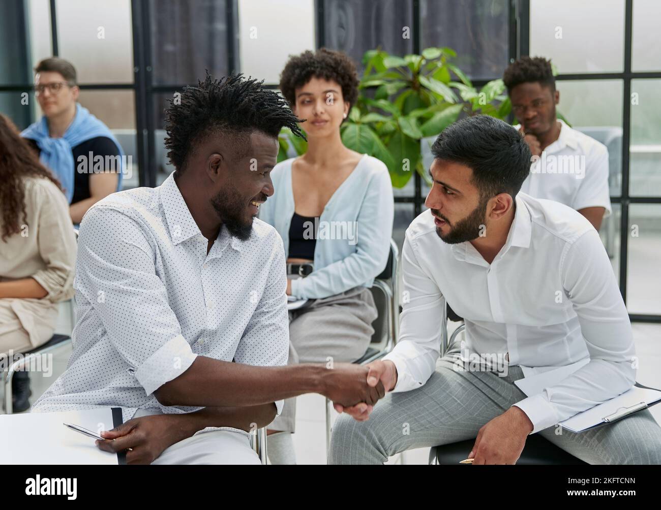 Positive multiracial diverse business people in formal and casual wear are discussing forum Stock Photo