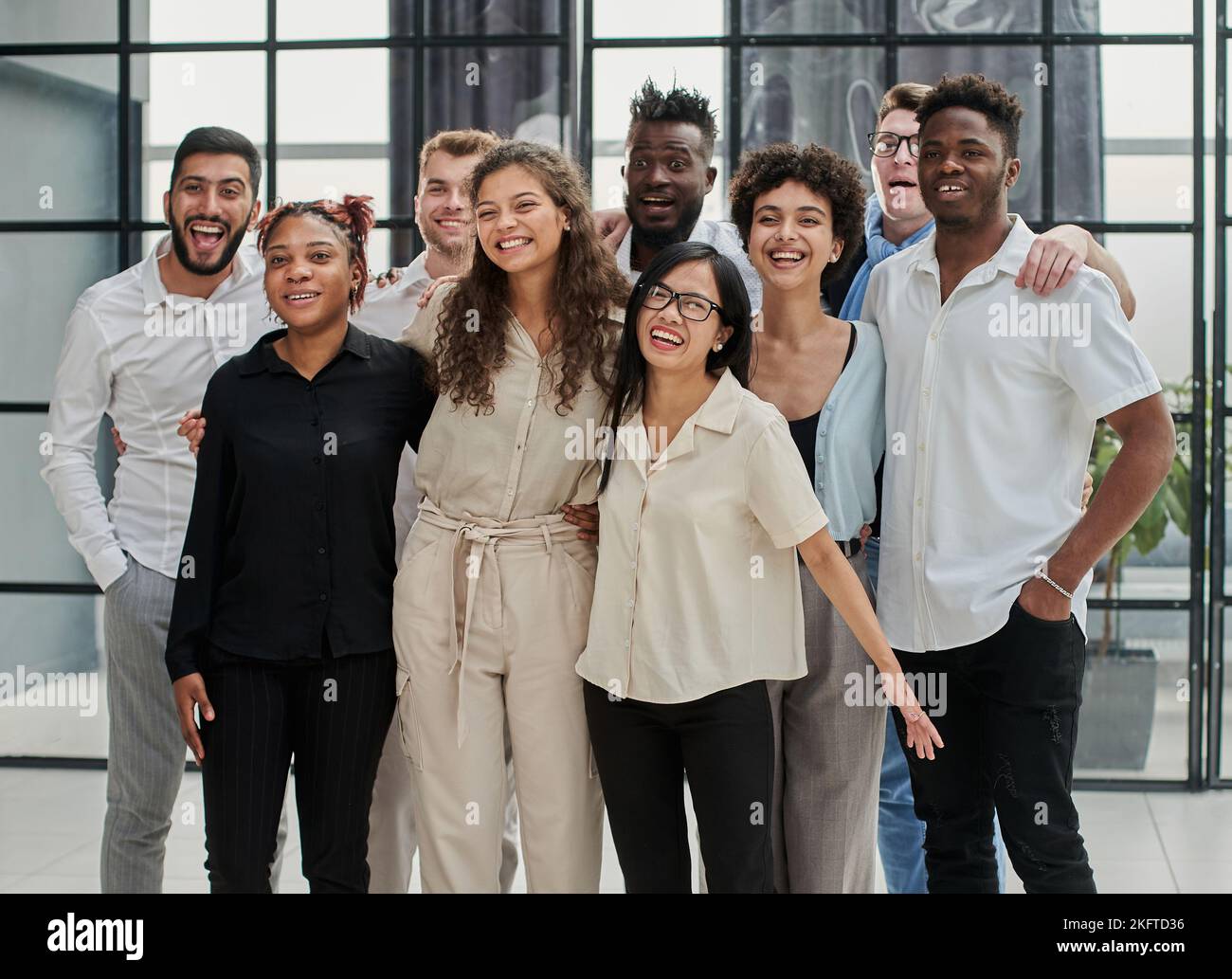 Team at work. Group of young business people in smart casual wear working together in creative office Stock Photo