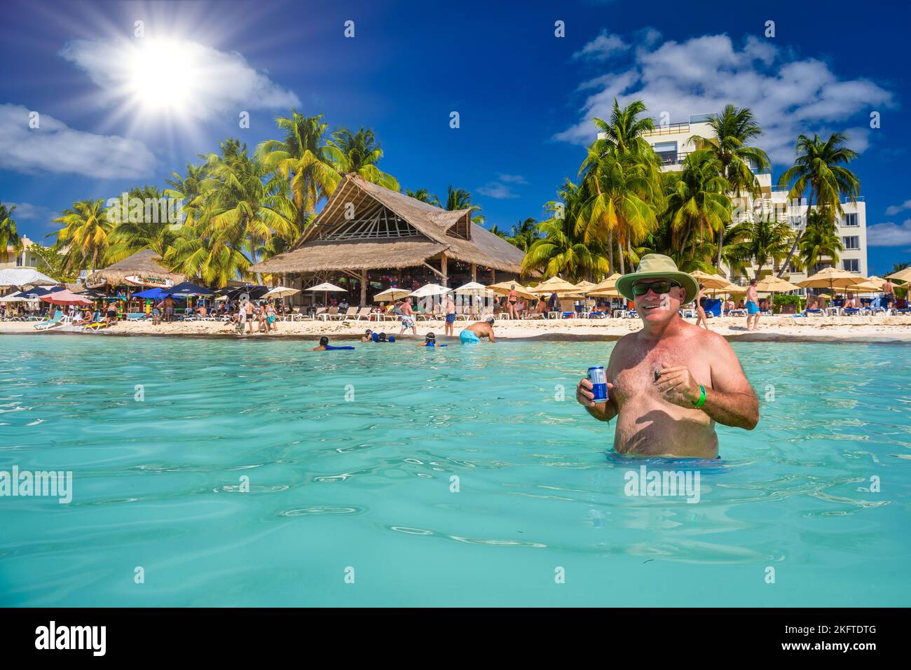ISLA MUJERES ISLAND, MEXICO APR 2022 Happy man with an energy drink