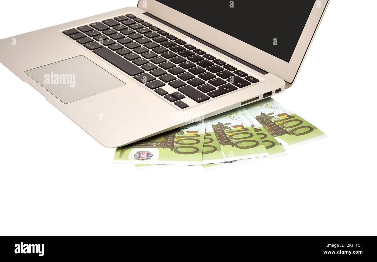 Portable computer and 100 euro bills on a white background Stock Photo ...