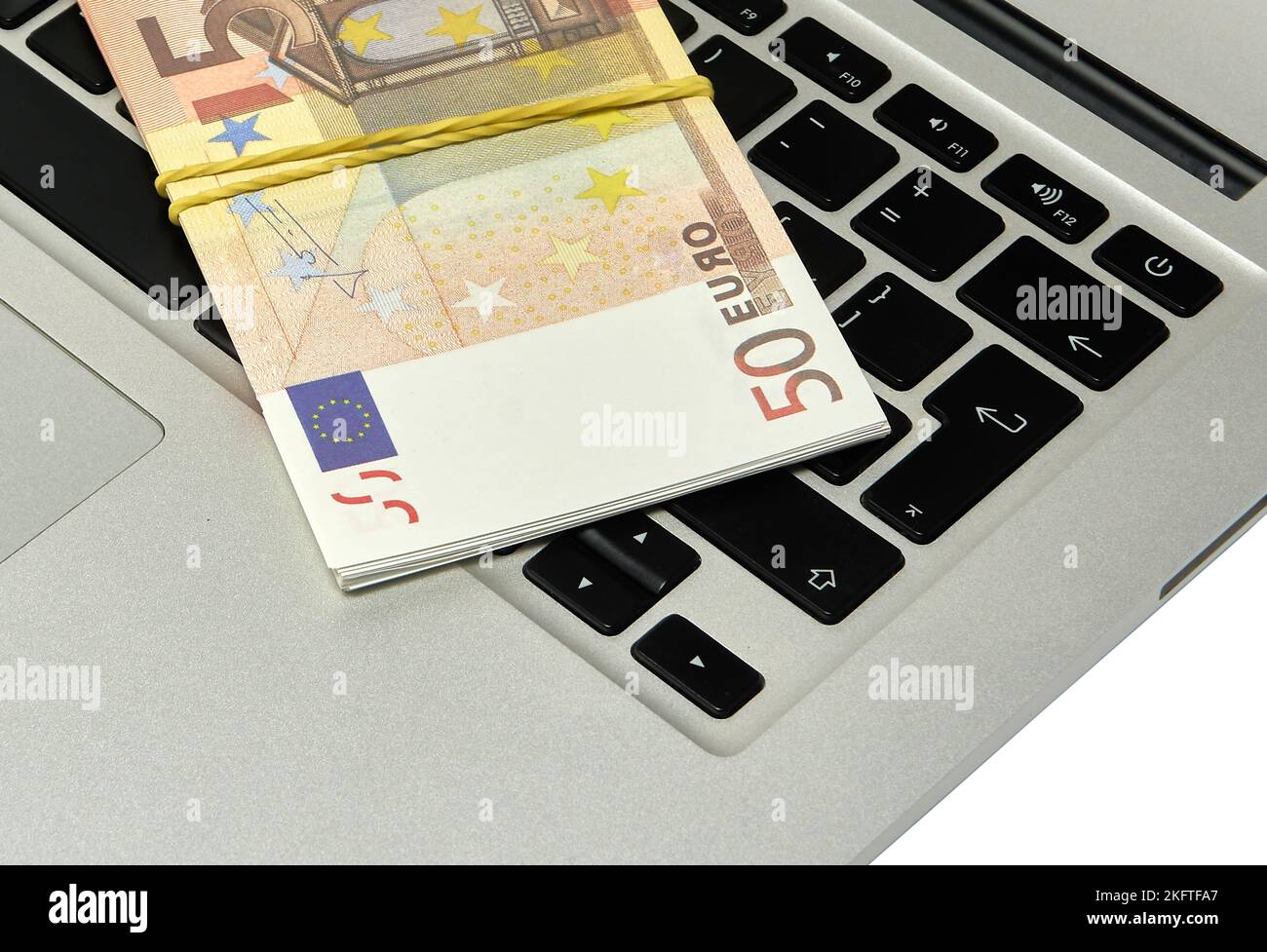 A bundle of 50 euro bills lying on a computer keyboard Stock Photo - Alamy