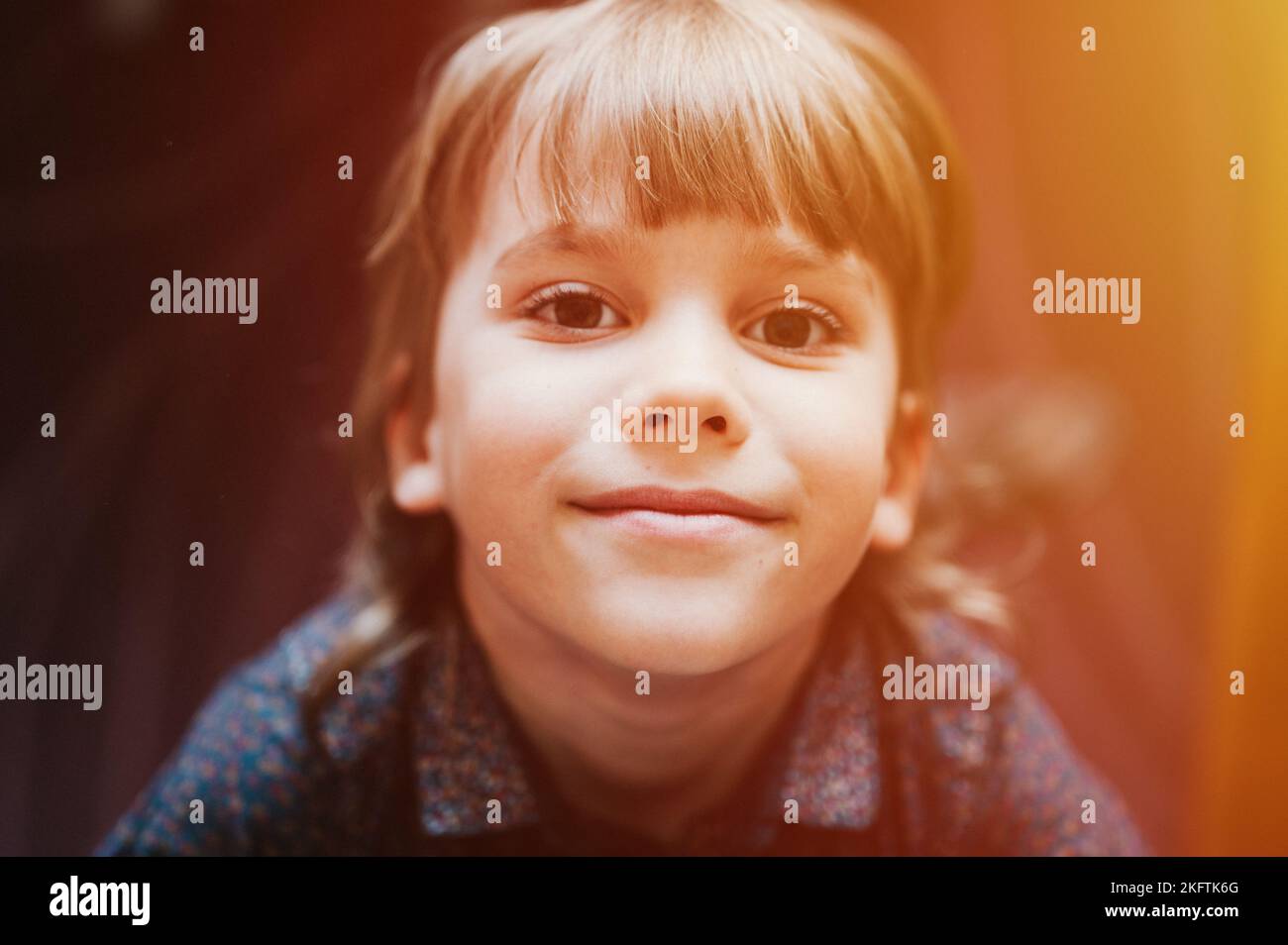 portrait of the face of cute happy smiling candid little six year old