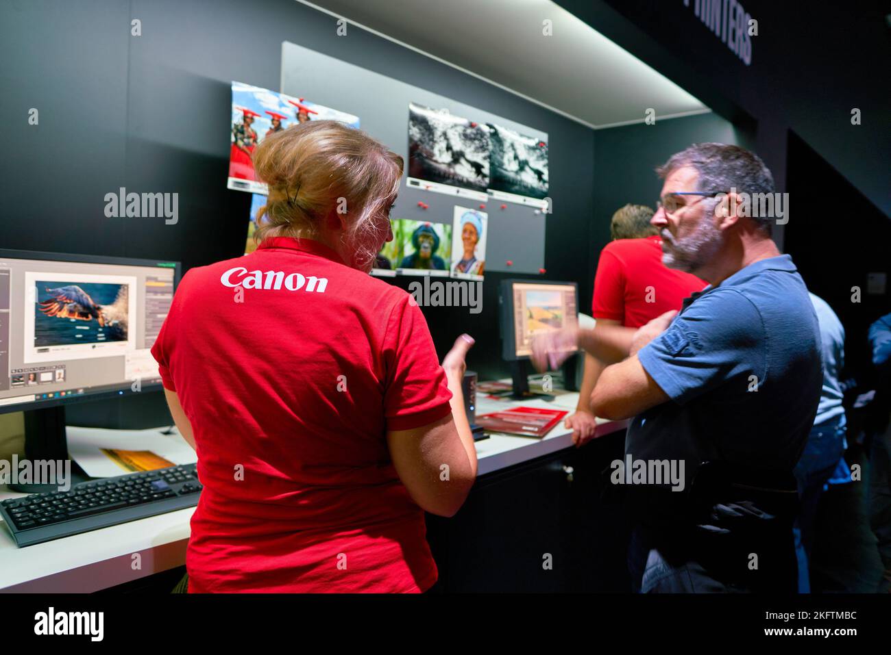 COLOGNE, GERMANY - CIRCA SEPTEMBER, 2018: Canon sign seen on red T-shirt of staff at the Photokina Exhibition. Photokina is a leading trade fair for t Stock Photo