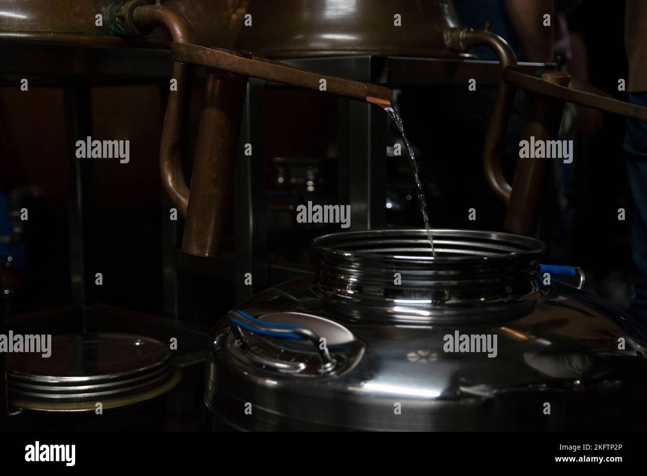 Whiskey distilling process - pouring into a tank Stock Photo - Alamy