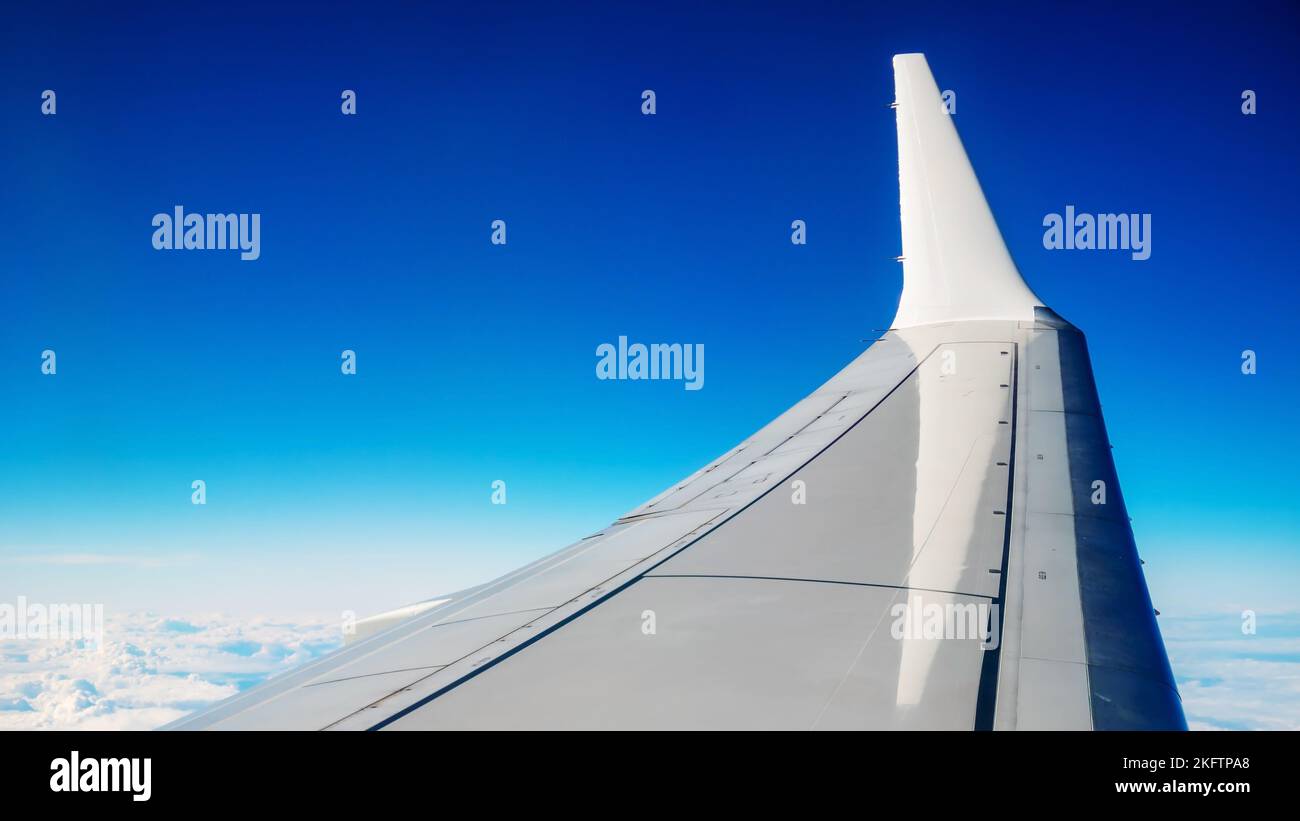 Boeing 737 MAX 8 White Wing Over White Air Clouds And Clear Blue Sky