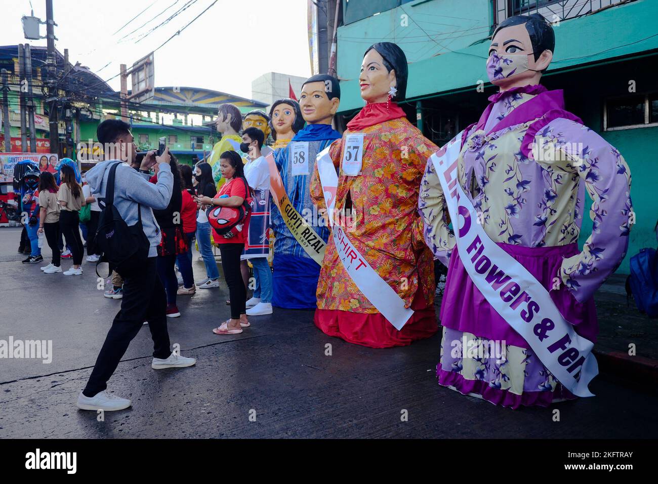 Angono, Rizal, Philippines. 20th Nov, 2022. The parade of the giant puppets in the art capital of the Philippines is back after two years of pandemic. The Higantes (giant) Festival parades the streets of Angono, Rizal province. The paper mache head puppets were originally done to put to shame corrupt officials during the Spanish rulership. Now, the Higantes came a long way and evolve into a festival on modern times from the Spanish era. The festival brings joy and entertainment to the town people of Angono and to tourists. Now, they wear a sash to represent someone or promote something with Stock Photo