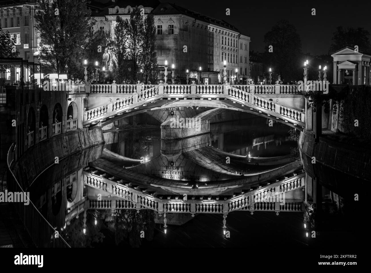 Famous three bridges at the Preseren square in the center of Ljubljana colorfully illuminated at night, Slovenia Stock Photo