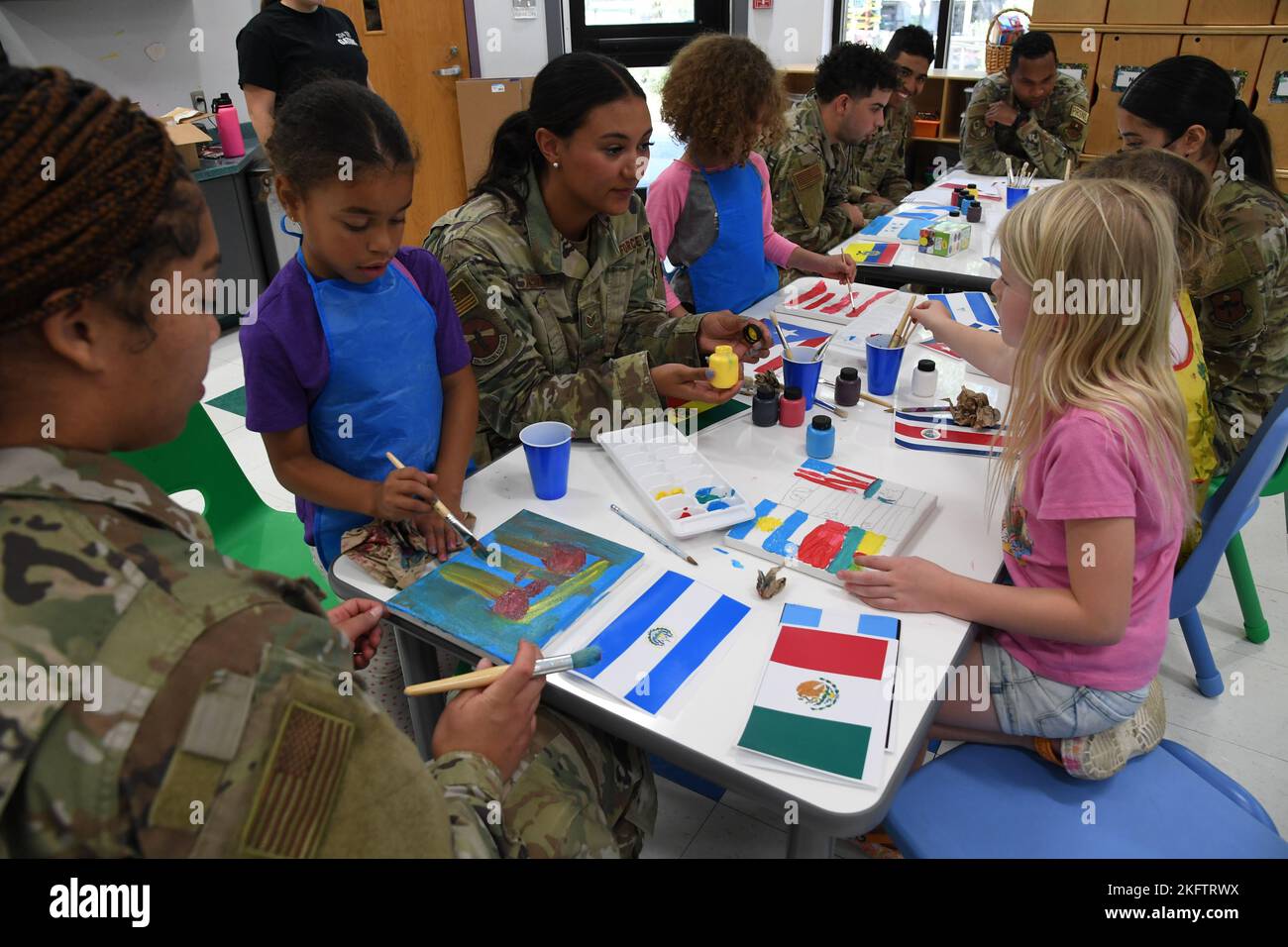 Keesler volunteers assist children at the youth center with an art