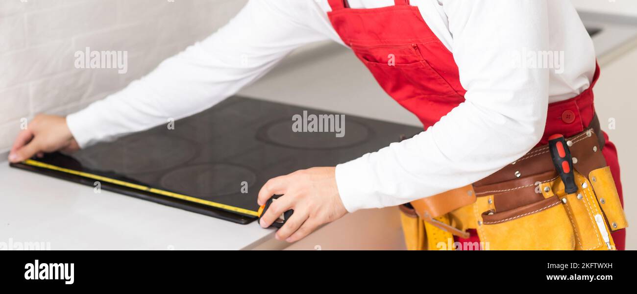 craftsman installs hob in kitchen. Household Appliance Installation