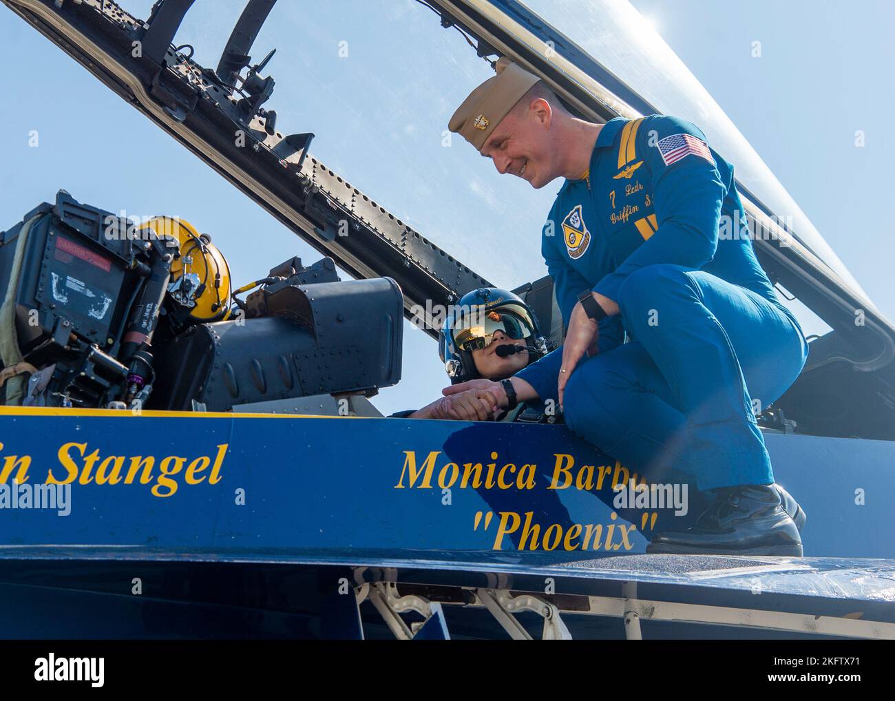 OAKLAND, California (Oct. 07, 2022) Navy Flight Demonstration Squadron, the Blue Angels' advance pilot and narrator, Lt. Cmdr. Griffen Stangel, performs a final preflight inspection prior to flying with Monica Barbaro, Top Gun: Maverick actress. The Blue Angels perform flight demonstrations at 32 locations across the country to showcase the teamwork and professionalism of the U.S. Navy and Marine Corps to the American public. Stock Photo