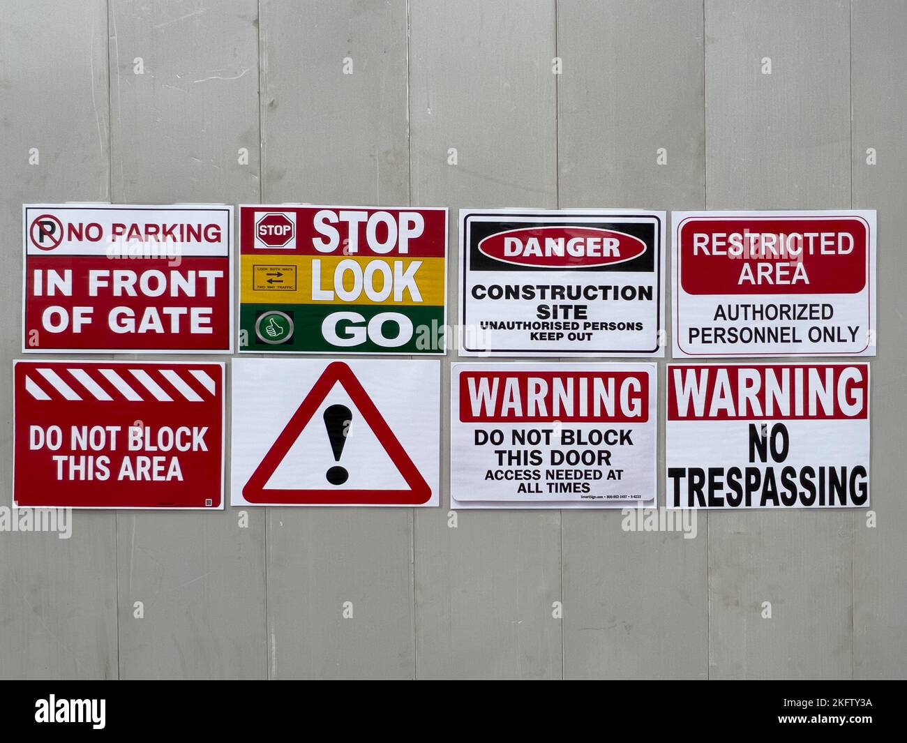A board pasted with various warning message stickers Stock Photo