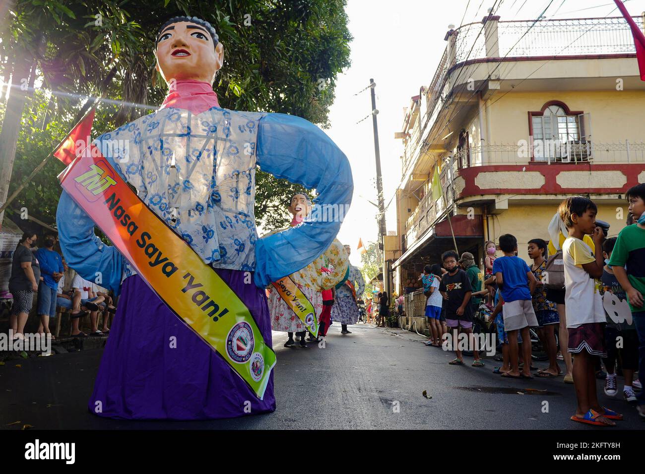 Angono, Rizal, Philippines. 20th Nov, 2022. The parade of the giant puppets in the art capital of the Philippines is back after two years of pandemic. The Higantes (giant) Festival parades the streets of Angono, Rizal province. The paper mache head puppets were originally done to put to shame corrupt officials during the Spanish rulership. Now, the Higantes came a long way and evolve into a festival on modern times from the Spanish era. The festival brings joy and entertainment to the town people of Angono and to tourists. Now, they wear a sash to represent someone or promote something with Stock Photo