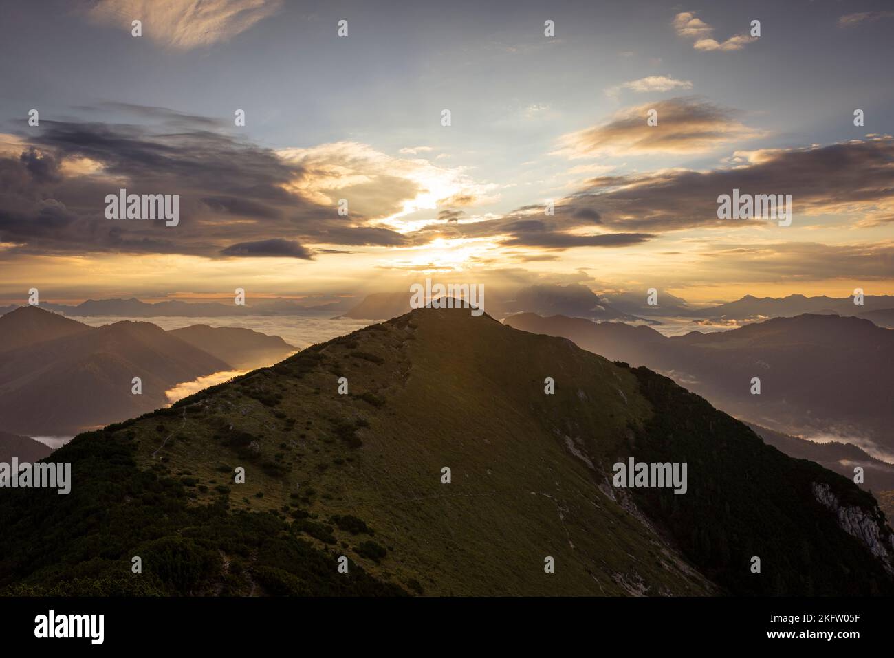 View from Mount Frechjoch to the sunrise over the Veitsberg and the Kaiser Mountains, Tyrol, Austria Stock Photo