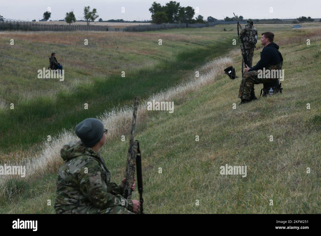 Airmen and families from the 97th Air Mobility Wing wait during a dove