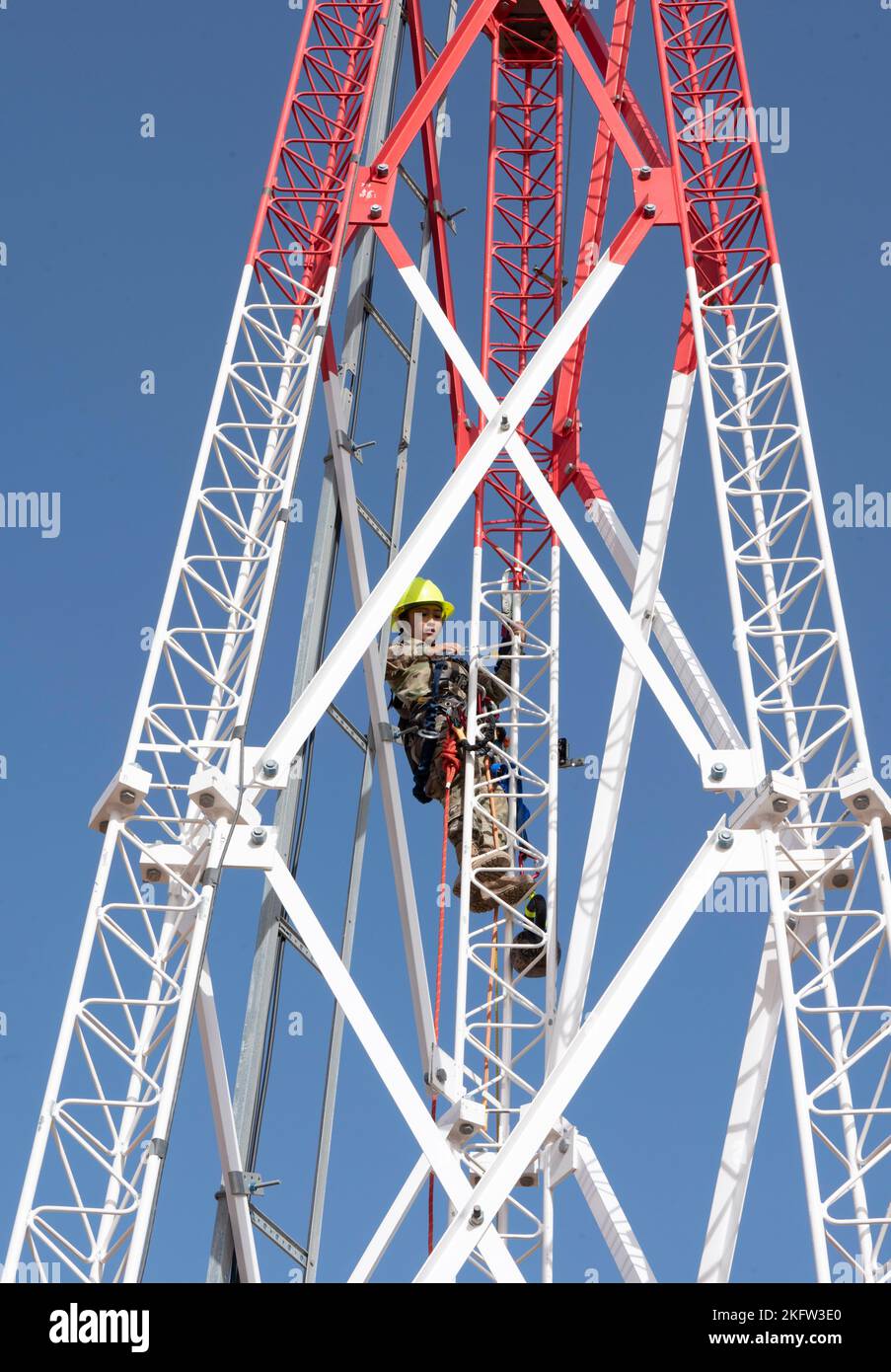 AIR BASE 201, Niger - U.S. Air Force Staff Sgt. Rachelle Russell, 435th Air Expeditionary Wing/ A6CT, cyber systems craftsman, climbs an Enterprise Land Mobile Radio (ELMR) tower during annual rescue training at Air Base 201, Niger, Oct. 8, 2022. Engineering and Installation  can be described as a corps of telecommunication engineers and the functional intermediary between civil engineers and information technology professionals. Stock Photo