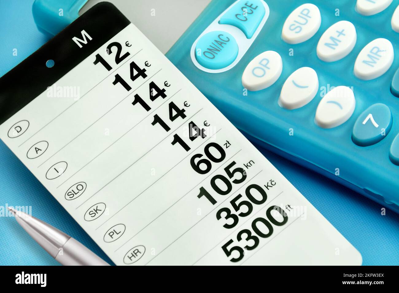 Price tag with international prices and blue calculator Stock Photo Alamy