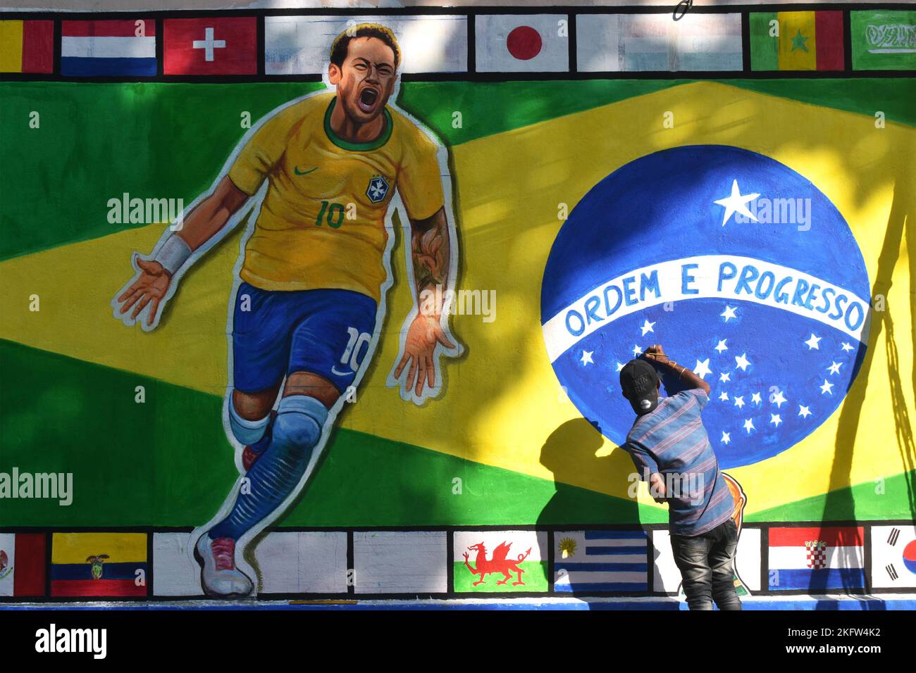 Kolkata, India. 20th Nov, 2022. A painter applies finishing touches to an image of Brazil's national flag with Neymar da Silva Santos Júnior, on a wall along a road ahead of the FIFA World Cup, in Kolkata. (Photo by Sudipta Das/Pacific Press) Credit: Pacific Press Media Production Corp./Alamy Live News Stock Photo