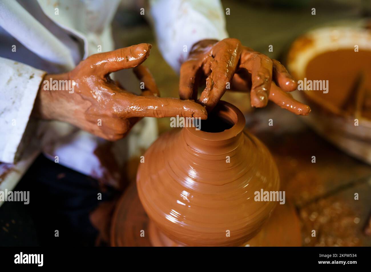 Craftsman moulding a piece of pottery on an Arab potter's wheel. Stock Photo