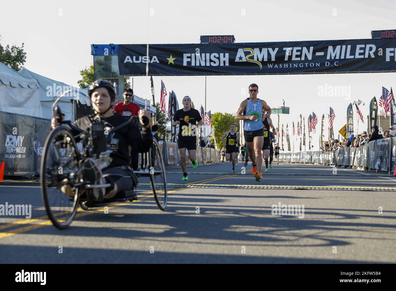 Participants cross the finish line during the Army 10Miler race Oct. 9