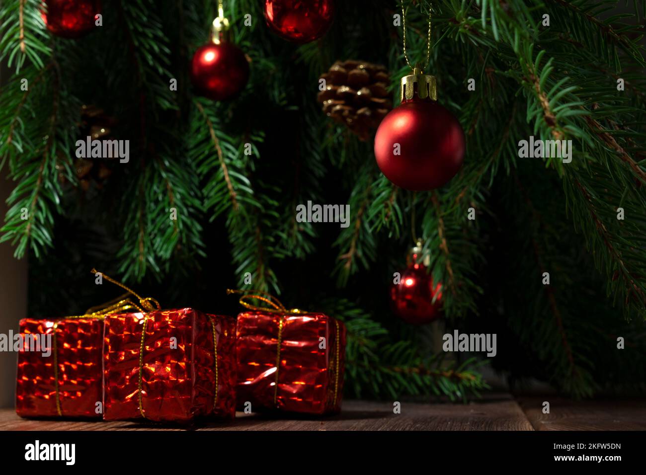 Red Christmas gifts on the background of the Christmas tree, Christmas composition Stock Photo