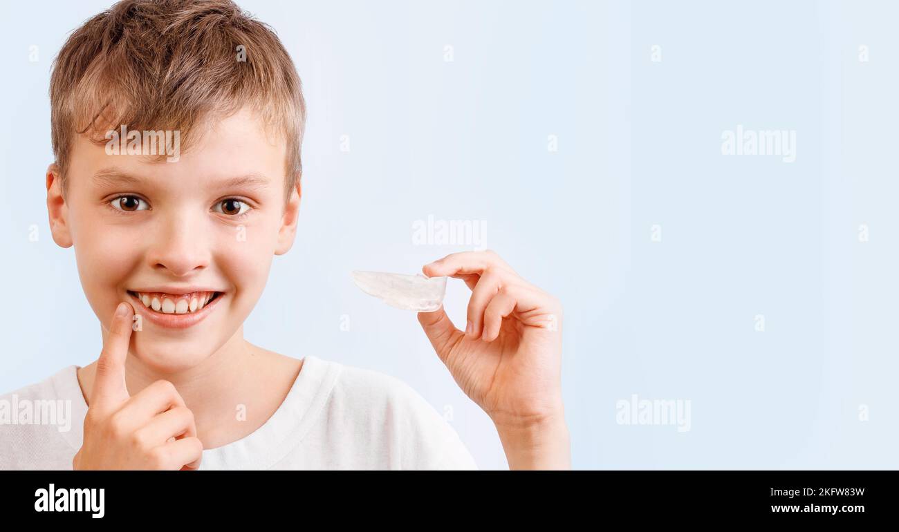 Boy is wearing orthodontic silicone trainer or nightguard case Stock