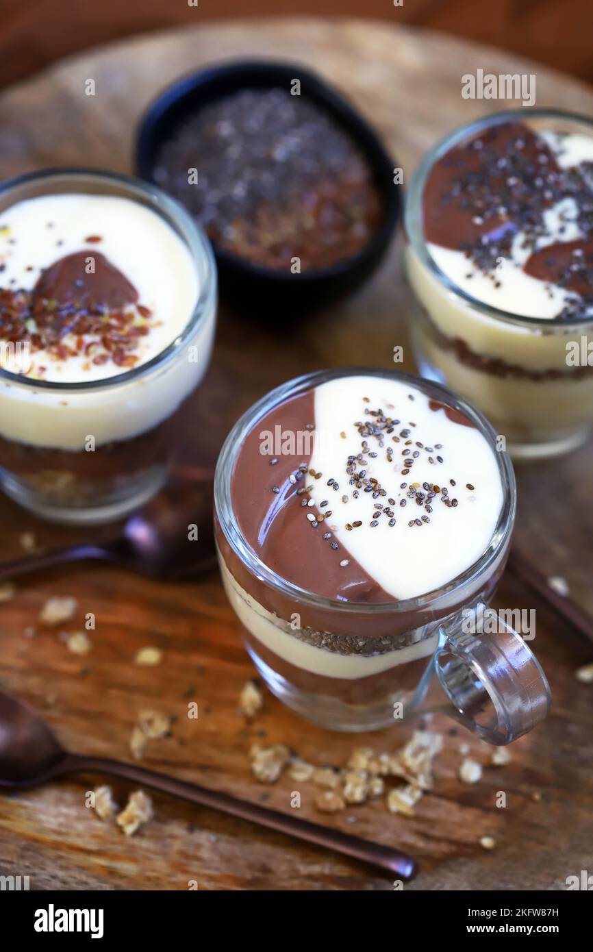 Healthy desserts in mugs. Vanilla and chocolate puddings with chia