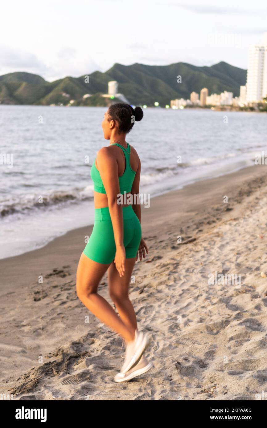Young woman doing some warm-up exercises before running. Stock Photo