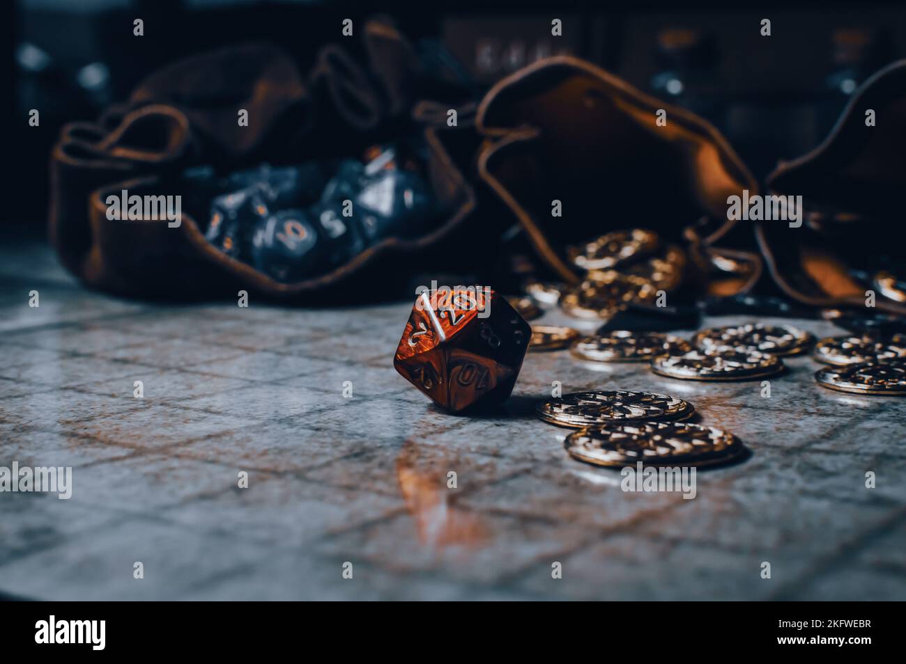Red roleplaying gaming die on a gaming grid with game coins and dice bags Stock Photo Alamy