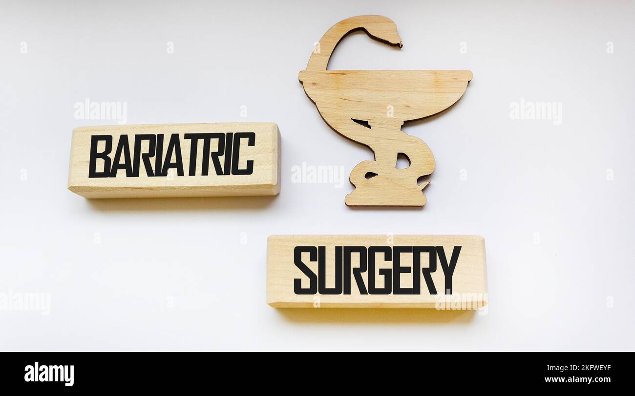 Wooden blocks with bariatric surgery text on white background with medicine sign .Medical concept. Stock Photo