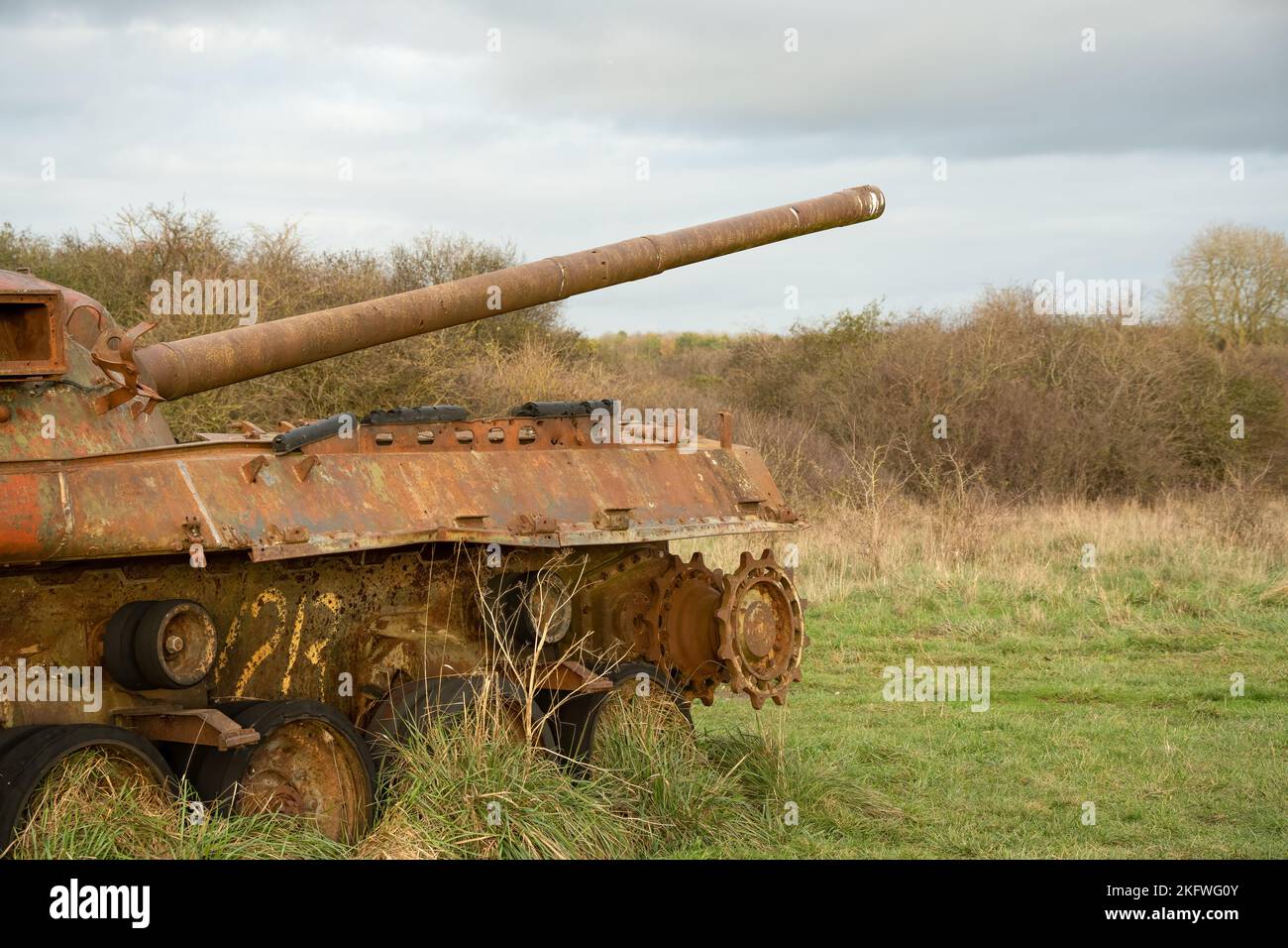 an abandoned rusting British FV4201 Chieftain main battle tank wreck in afternoon sunlight Stock Photo