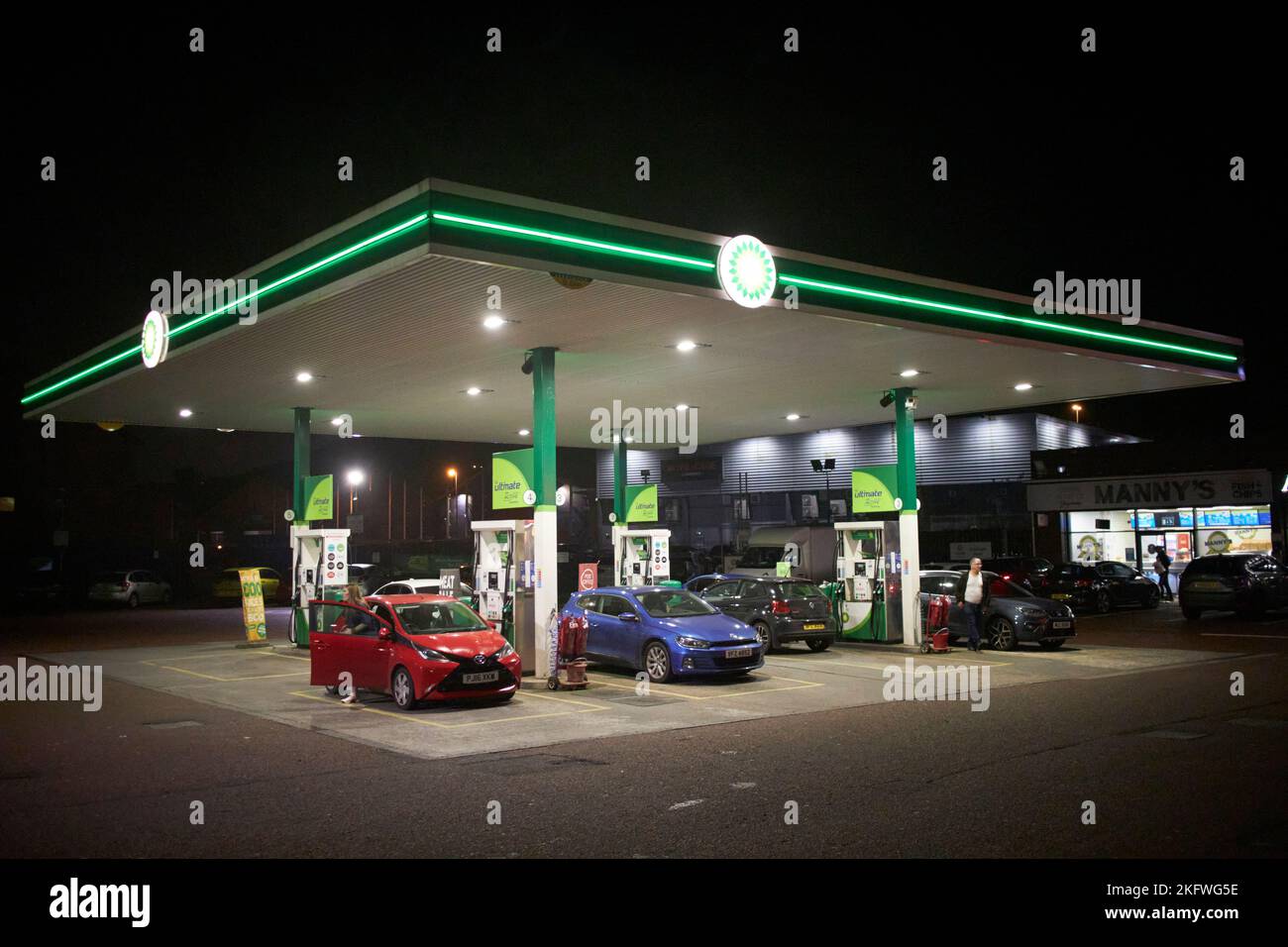 bp garage service station at night with cars refuelling in the uk Stock Photo