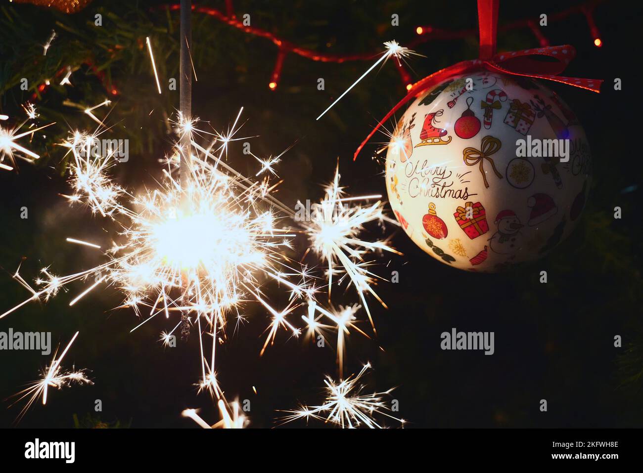 Sparkler burning on a Christmas tree.Christmas tree decoration and sparkler close-up Stock Photo