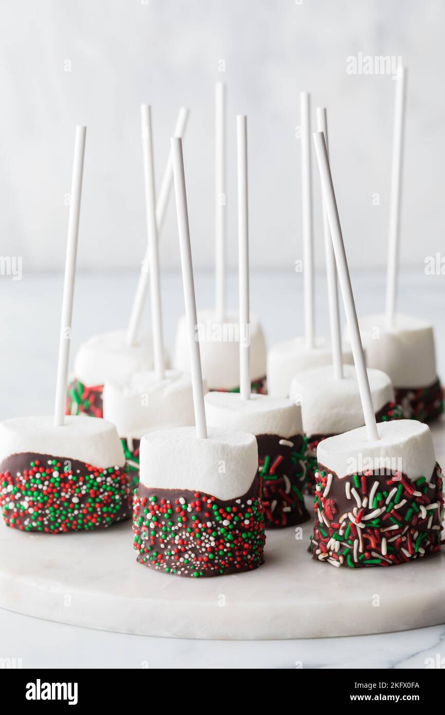 Large chocolate dipped marshmallow pops covered in festive sprinkles