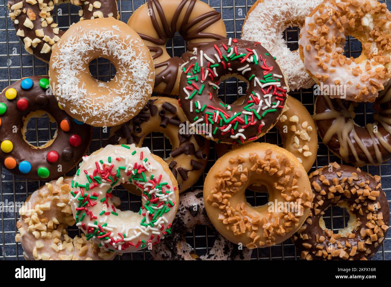 A pile of delicious homemade donuts with various glazes and toppings. Stock Photo