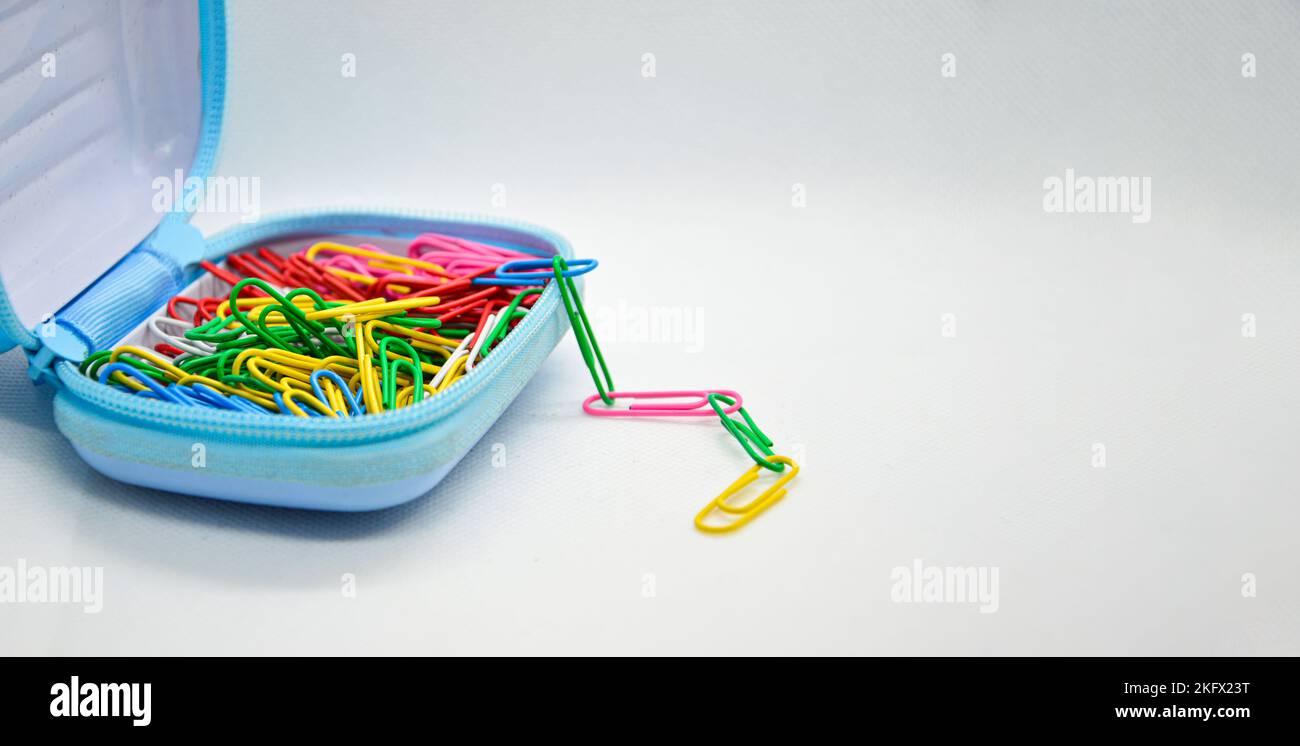 Colorful paperclips in blue pockets Stock Photo