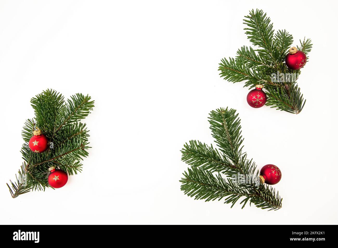 Christmas Fir twigs isolated on white background. Xmas decoration, fresh pine branch and red bauble. Stock Photo