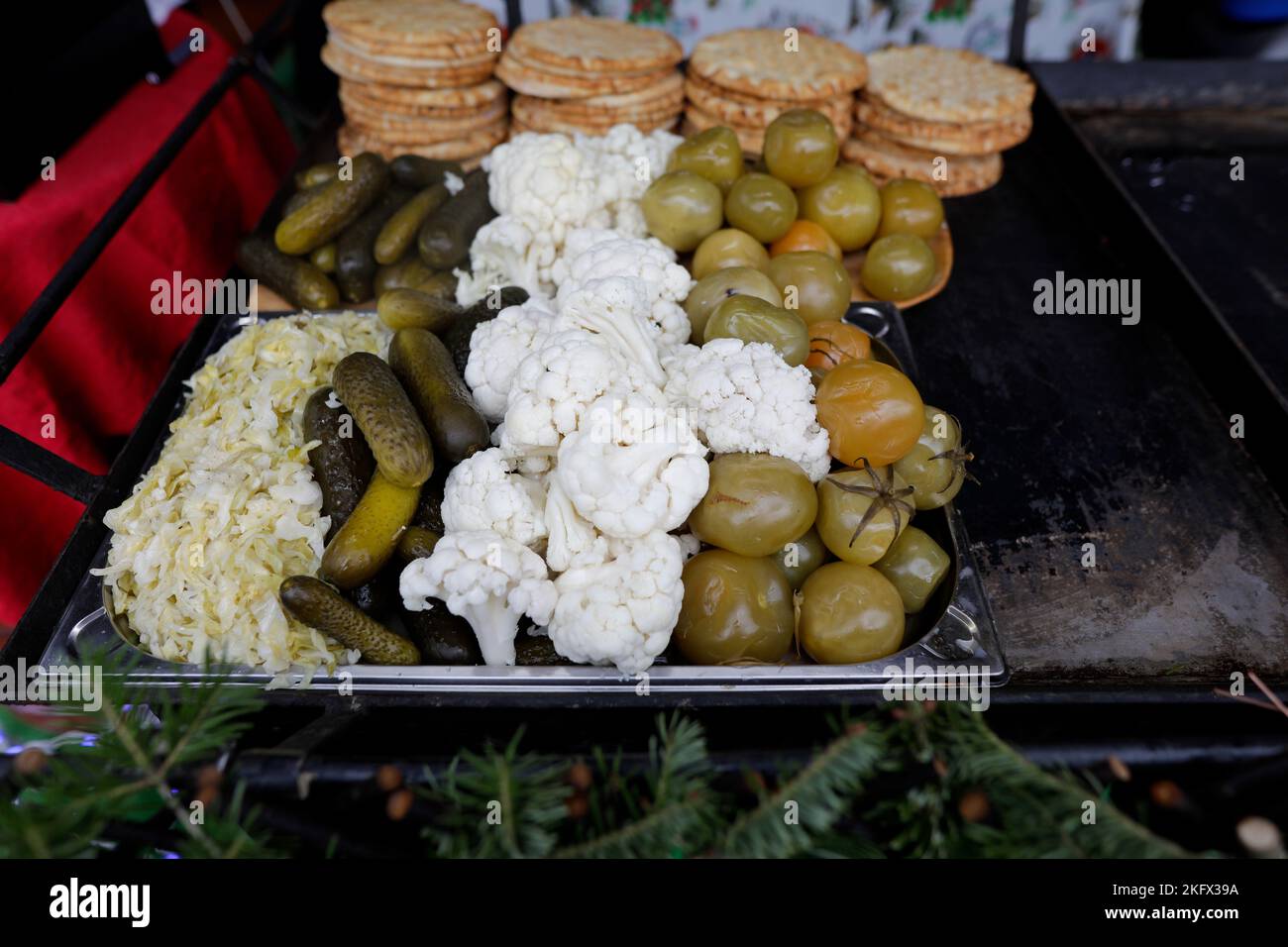 Shallow depth of field (selective focus) details with pickles (cucumber, cauliflower) in a European farmers market in Romania. Stock Photo