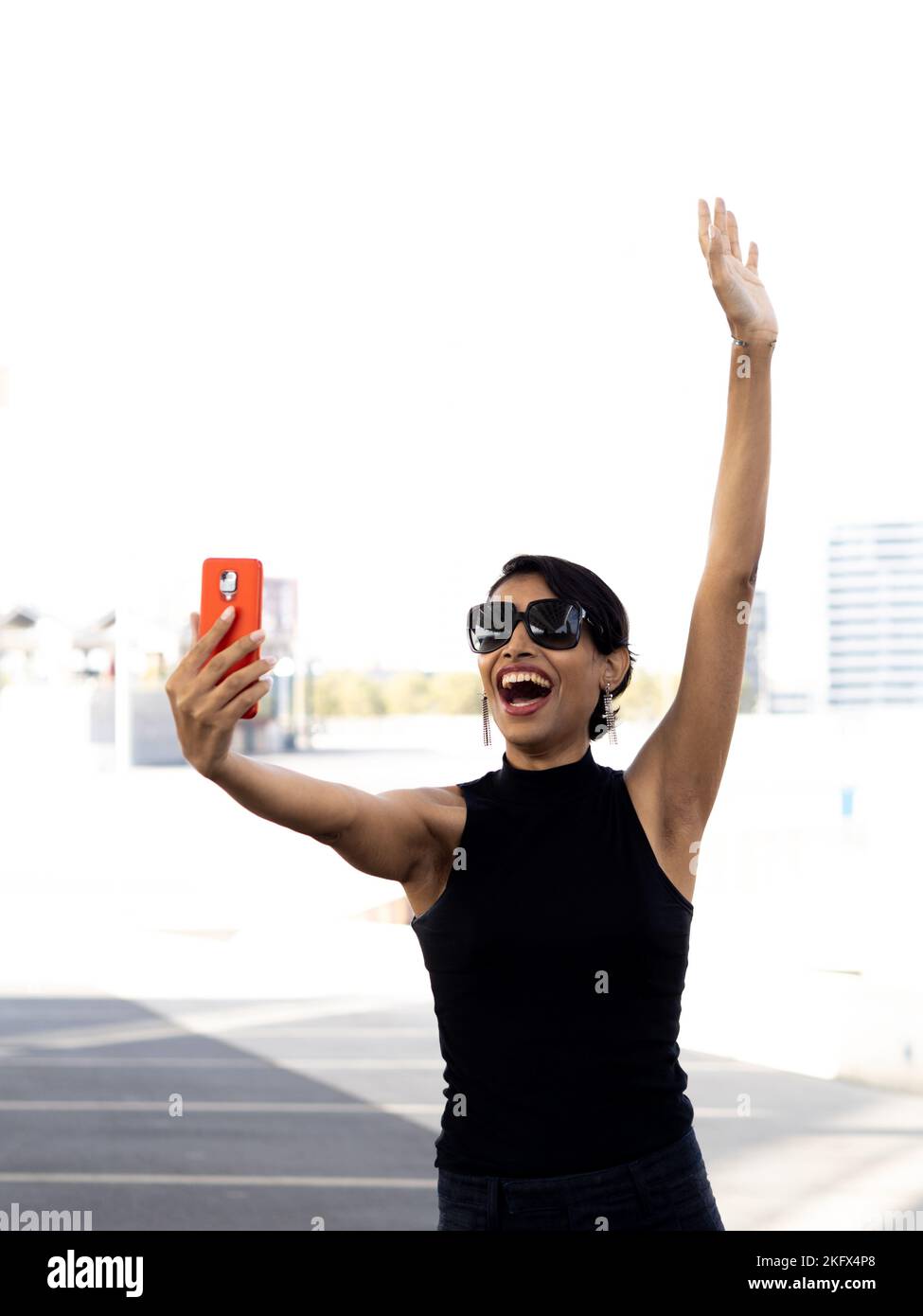 Smiling transgender woman taking a selfie in a city Stock Photo