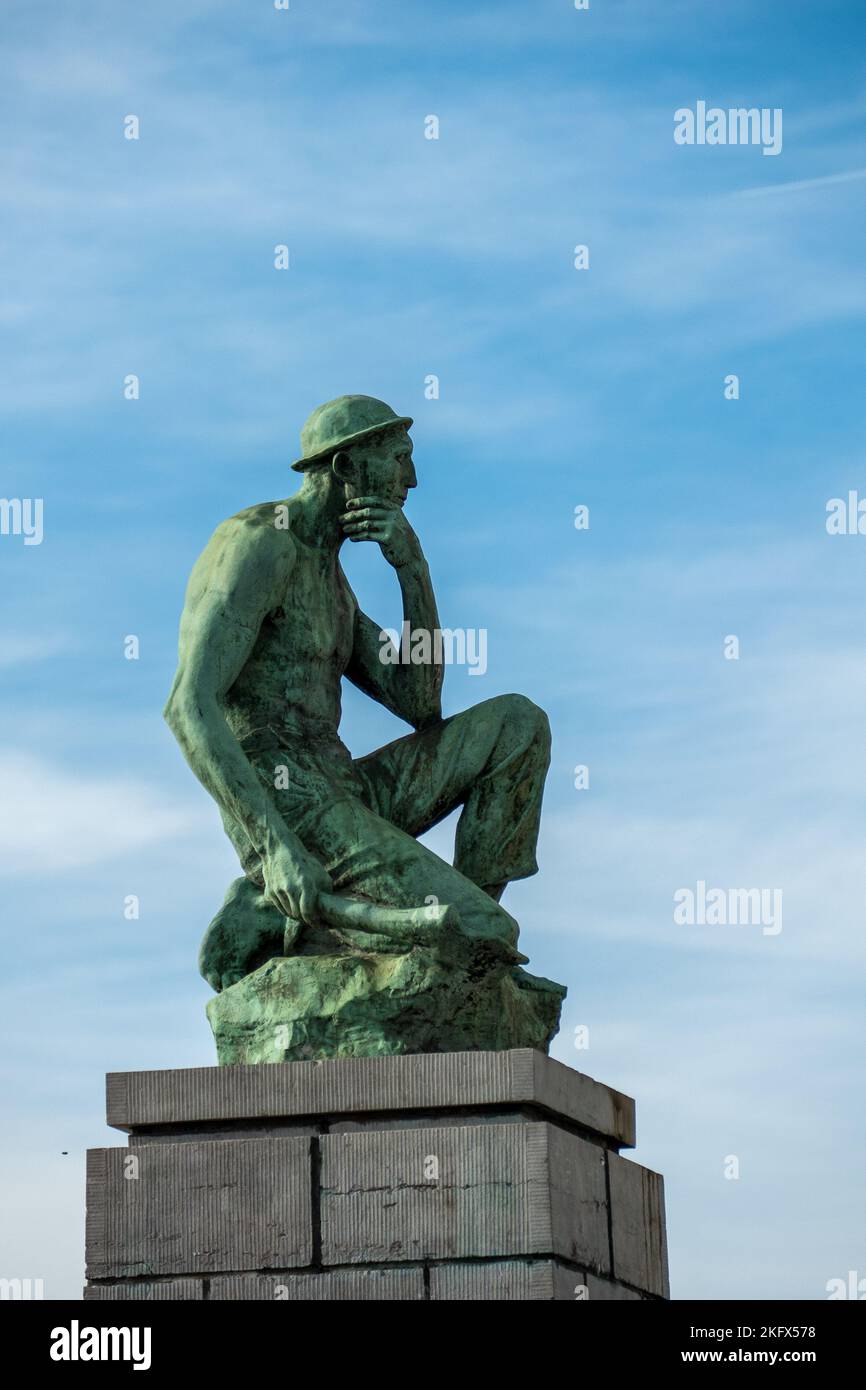 Charleroi, Belgium, November 11, 2022. The Crouching Miner located is a monument dedicated to Labor, designed by Constantin Meunier. Stock Photo