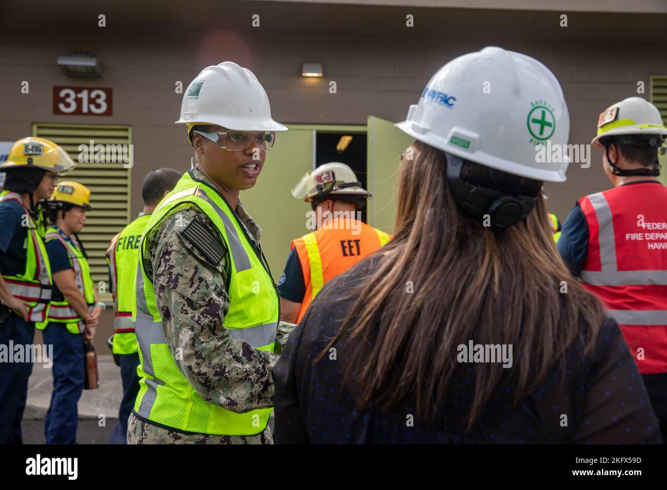 U.S. Navy Lt. Cmdr. Malia Gonzalez, Joint Task Force-Red Hill (JTF-RH) Safety Advisor, speaks with a stakeholder representative during a Red Hill Bulk Fuel Storage Facility (RHBFSF) Stakeholder Safety Walkthrough at the facility in Halawa, Hawaii, Oct. 12, 2022. JTF-RH was established by the Department of Defense to ensure the safe and expeditious defueling of the RHBFSF. Stock Photo