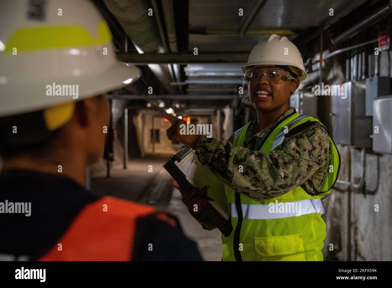 U.S. Navy Lt. Cmdr. Malia Gonzalez, Joint Task Force-Red Hill (JTF-RH) Safety Advisor, speaks with a first responder during a Red Hill Bulk Fuel Storage Facility (RHBFSF) Stakeholder Safety Walkthrough at the facility in Halawa, Hawaii, Oct. 12, 2022. JTF-RH was established by the Department of Defense to ensure the safe and expeditious defueling of the RHBFSF. Stock Photo