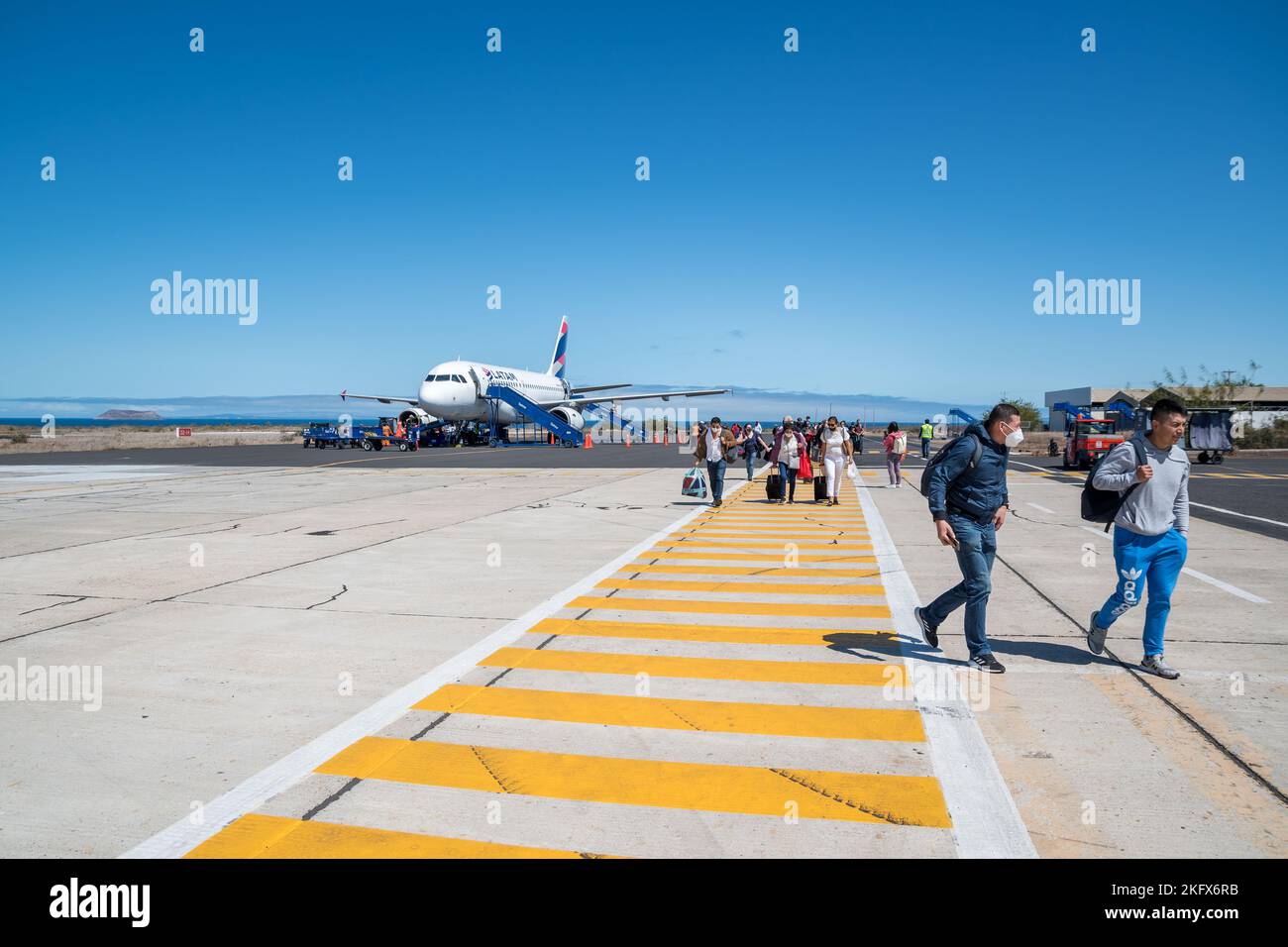 Passengers disembarking from the plane, Seymour Airport, Galapagos Islands Stock Photo