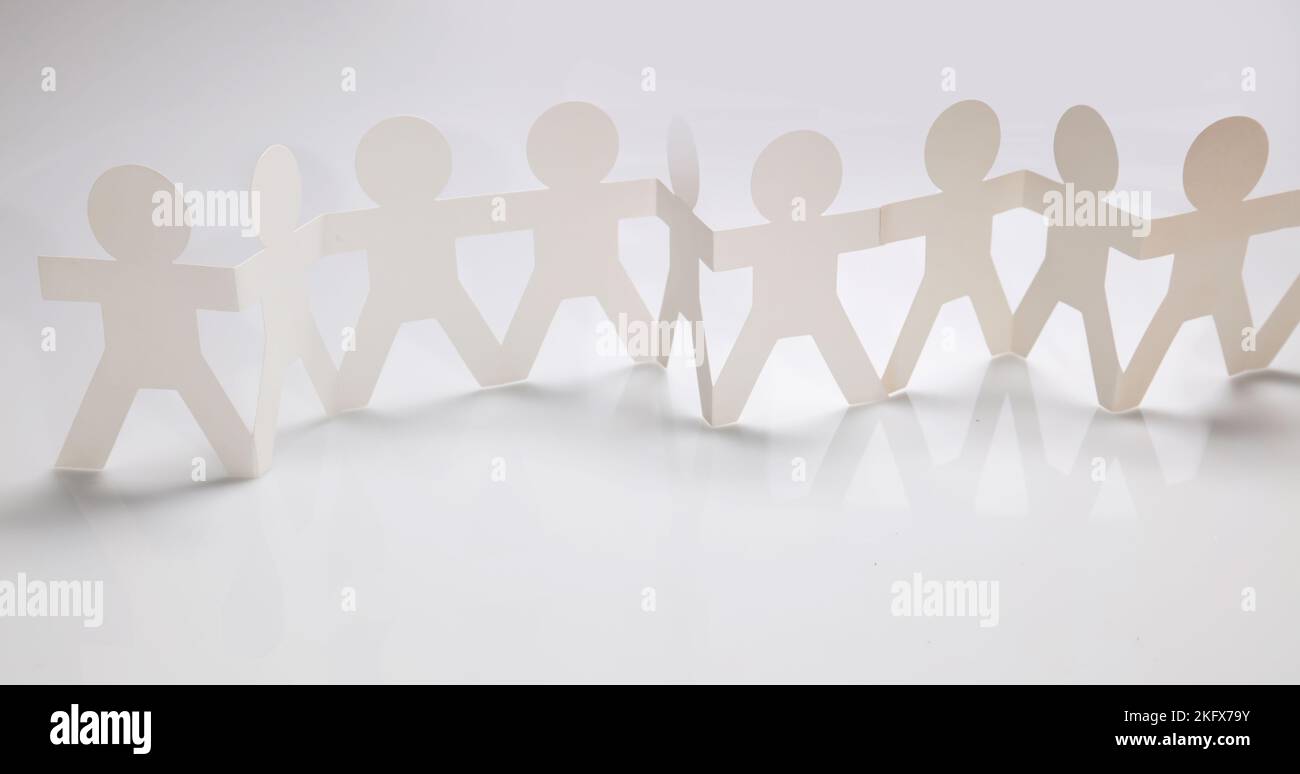 Paper chain team holding hands. Teamwork. Partnership Stock Photo Alamy
