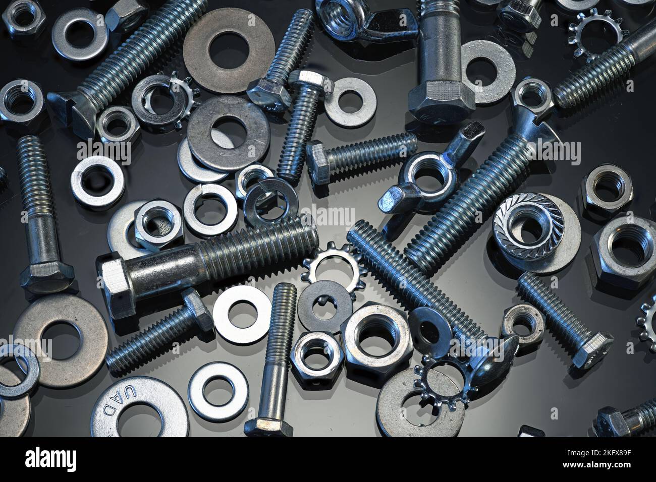 Nuts and Bolts on dark glass Stock Photo Alamy