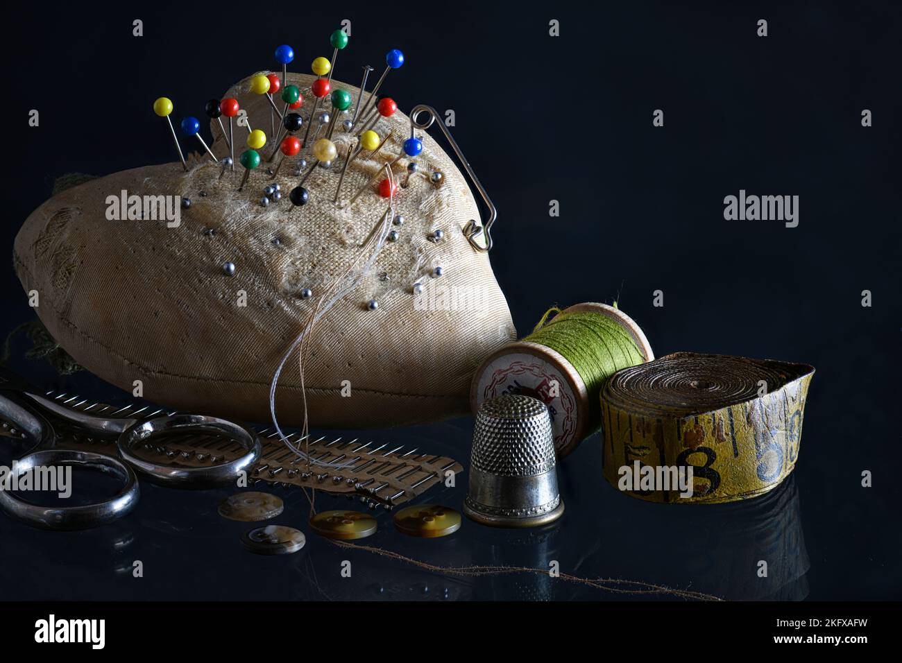 Vintage Sewing Pincushion with Needle, Thread, and Thimble. Stock Photo