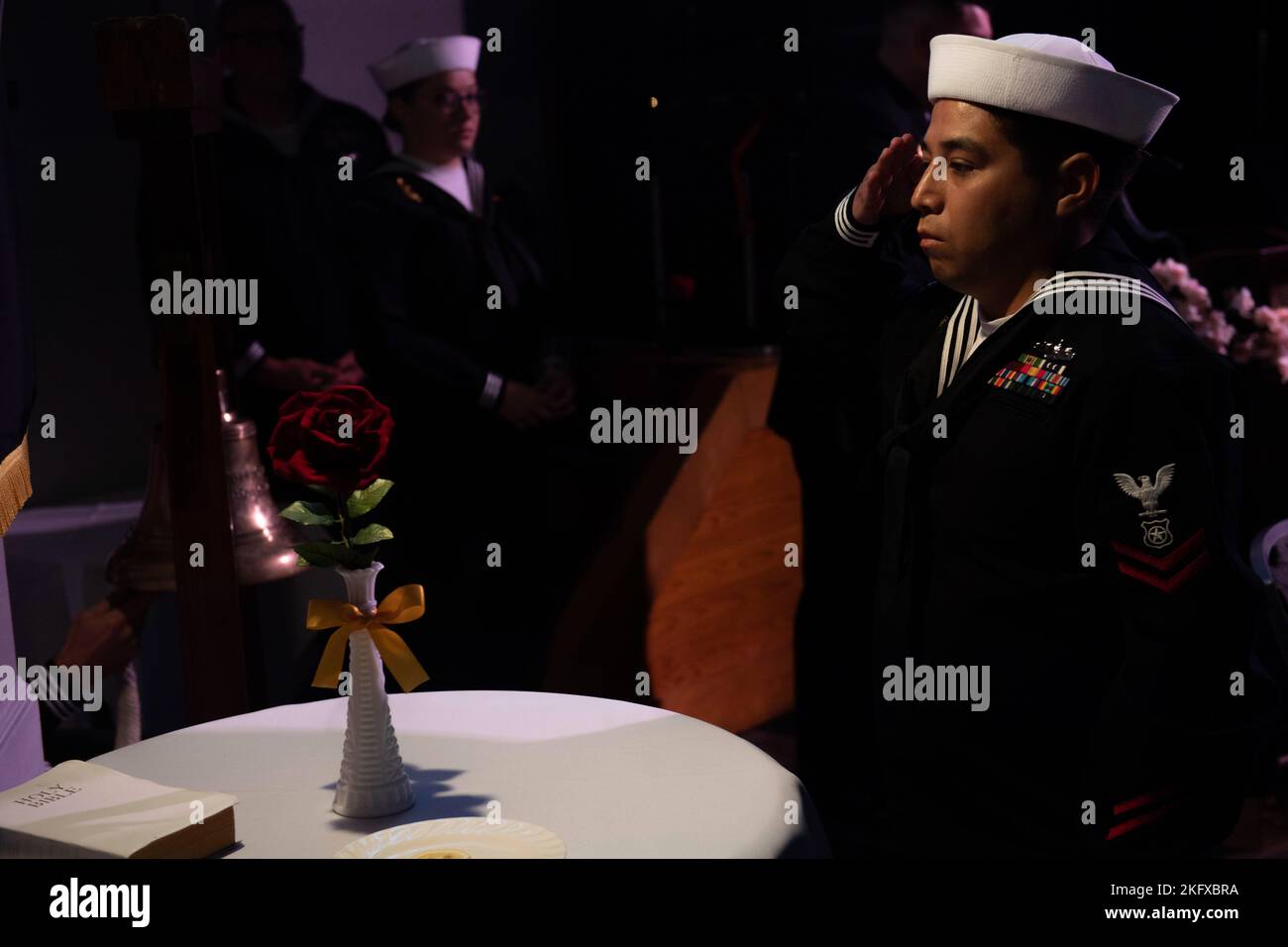 MasteratArms 2nd Class Emmanuel Murillomora salutes the POW/MIA table