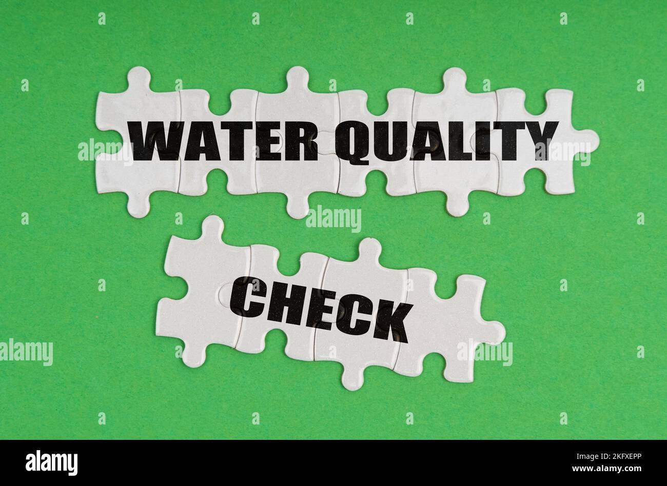 Environmental concept. On a green background, there are puzzles on which it is written - water quality check Stock Photo