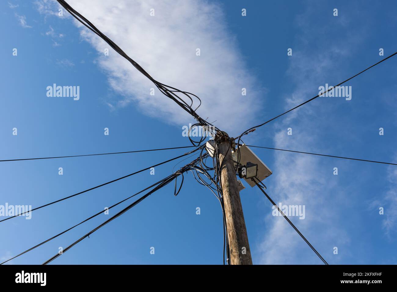 Wooden pole with electric cables Stock Photo