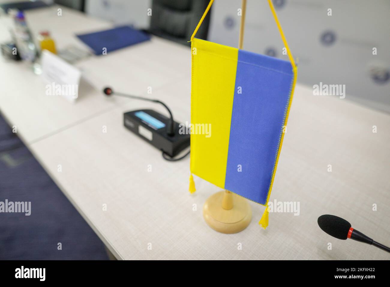 Shallow depth of field (selective focus) details with an Ukrainian flag during a press conference. Stock Photo