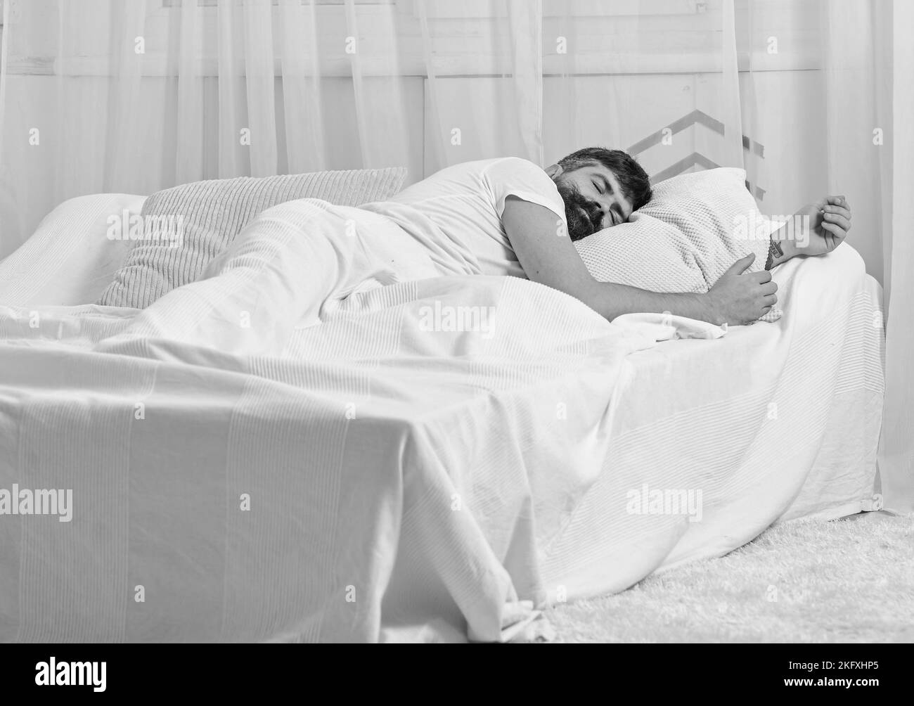 Guy on calm face sleeping on white sheets, pillow. Fast asleep concept